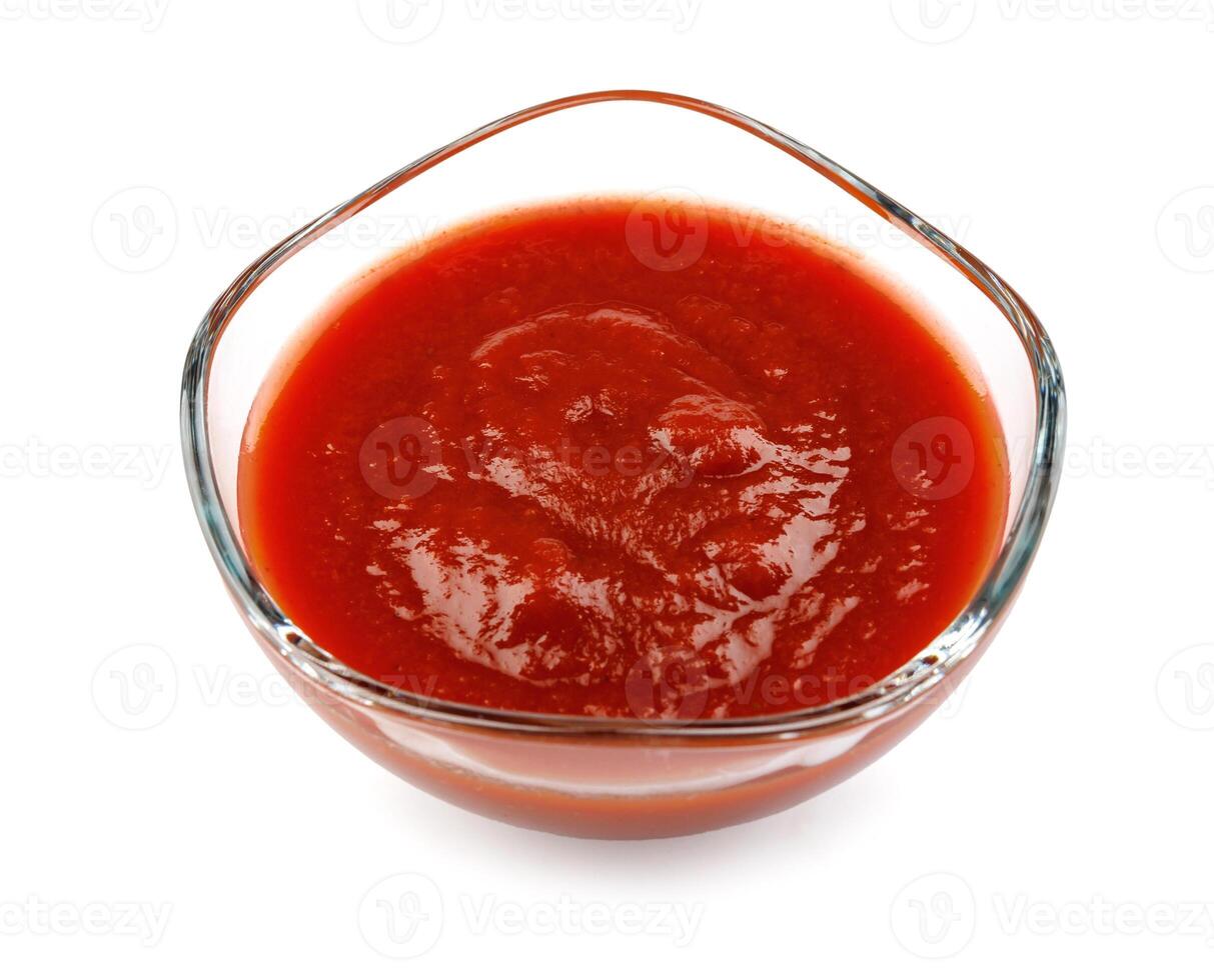 Ketchup in a glass cup isolated on a white background. Tomato sauce . photo