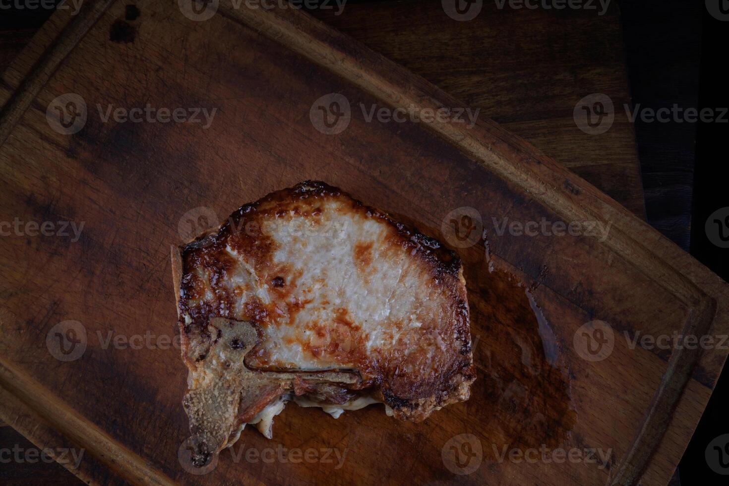 Roasted pork entrecote on a wooden cutting board. Grilled pork entrecote. Pork steak. photo