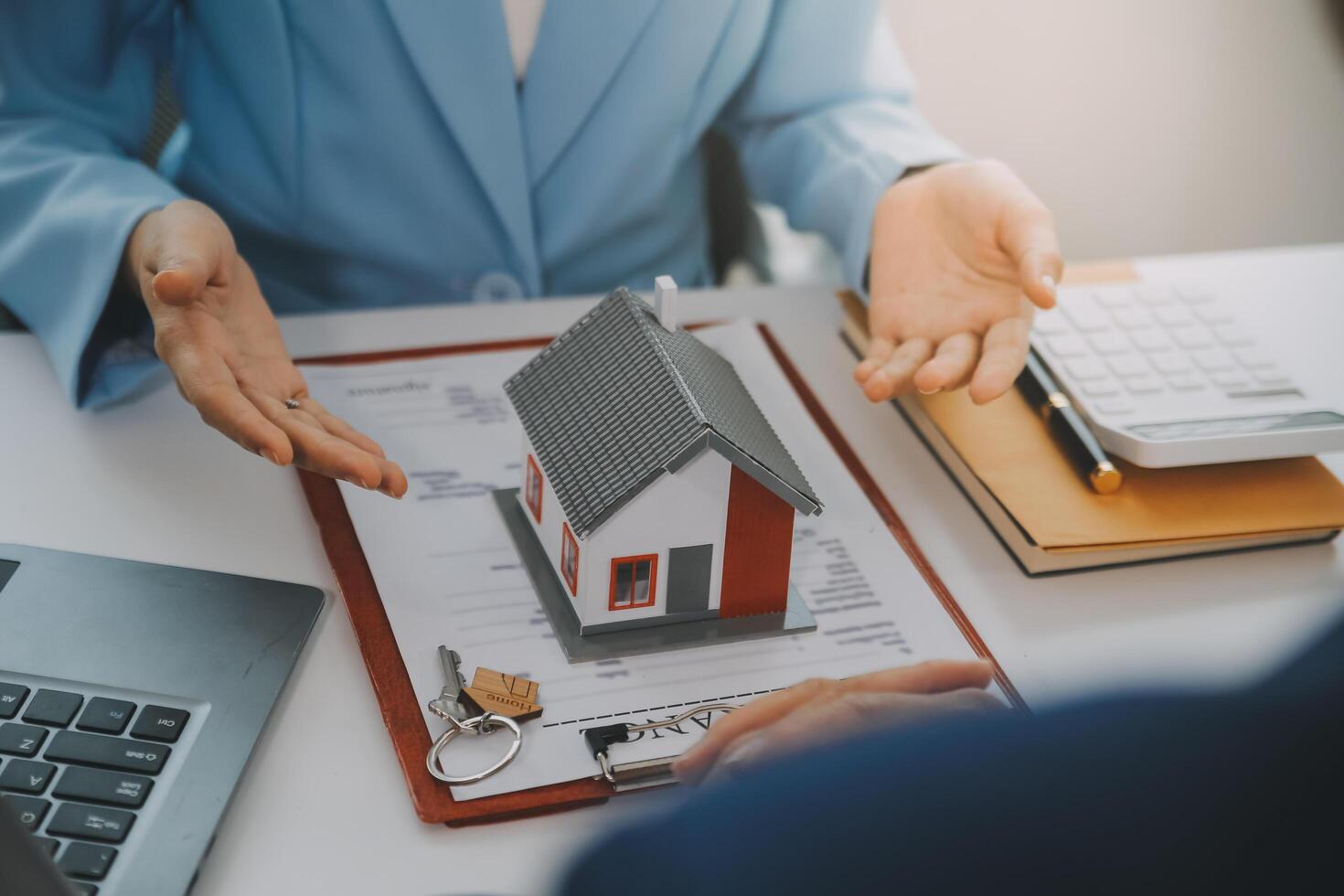 Real estate agent talked about the terms of the home purchase agreement and asked the customer to sign the documents to make the contract legally, Home sales and home insurance concept. photo