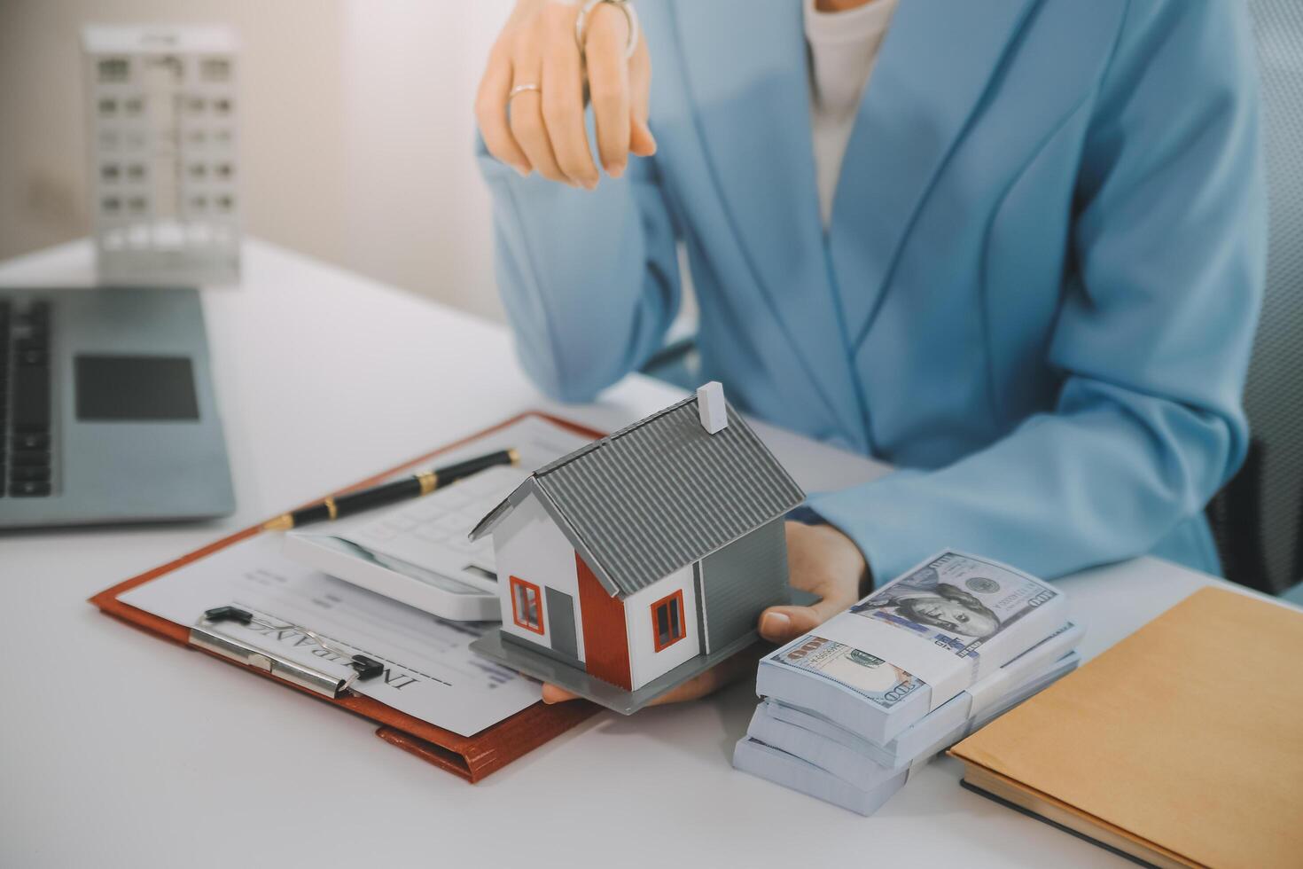 Real estate agent talked about the terms of the home purchase agreement and asked the customer to sign the documents to make the contract legally, Home sales and home insurance concept. photo