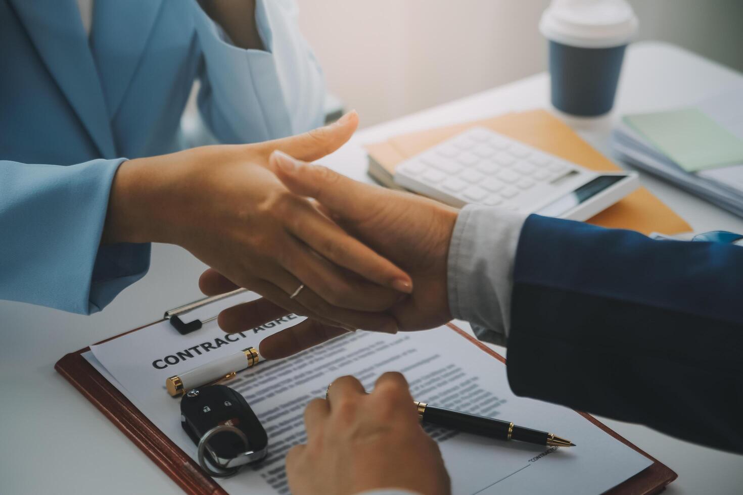 Insurance officers hand over the car keys after the tenant. have signed an auto insurance document or a lease or agreement document Buying or selling a new or used car with a car photo