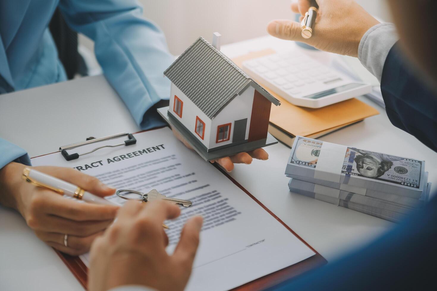 Real estate agent talked about the terms of the home purchase agreement and asked the customer to sign the documents to make the contract legally, Home sales and home insurance concept. photo