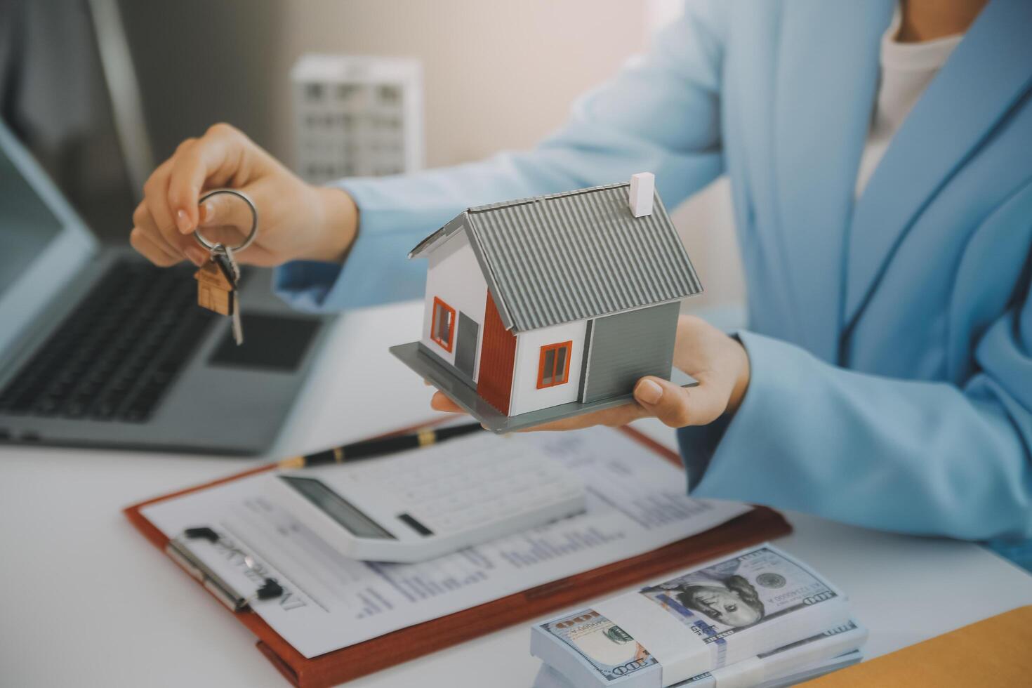 Real estate agent talked about the terms of the home purchase agreement and asked the customer to sign the documents to make the contract legally, Home sales and home insurance concept. photo