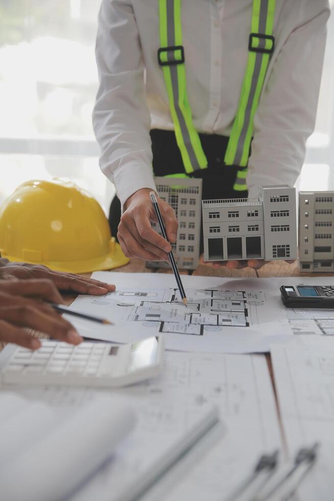 Construction and structure concept of Engineer or architect meeting for project working with partner and engineering tools on model building and blueprint in working site, contract for both companies. photo