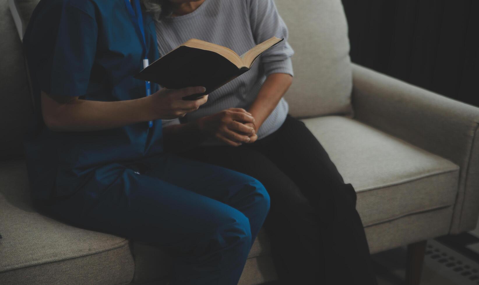 Happy young female nurse provide care medical service help support smiling old grandma at homecare medical visit, lady carer doctor give empathy encourage retired patient sit on sofa at home hospital photo