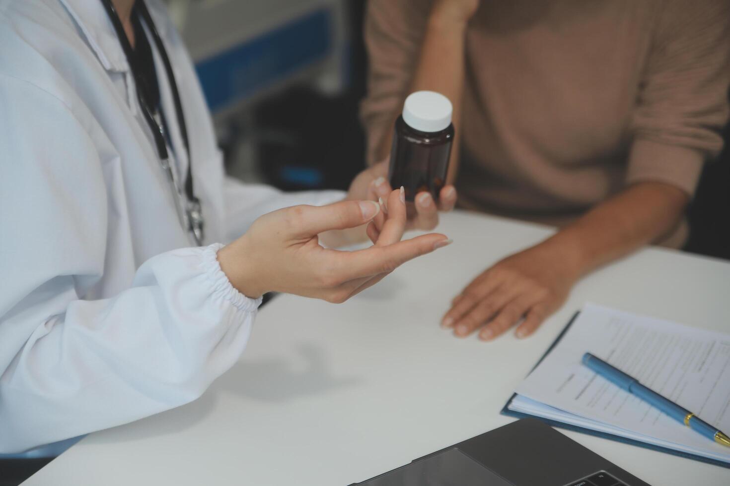 Smiling woman doctor prescribing medicine giving vitamins bottle to happy senior grandmother patient sit on sofa during medical healthcare visit, older people pharmacy medication treatment concept photo