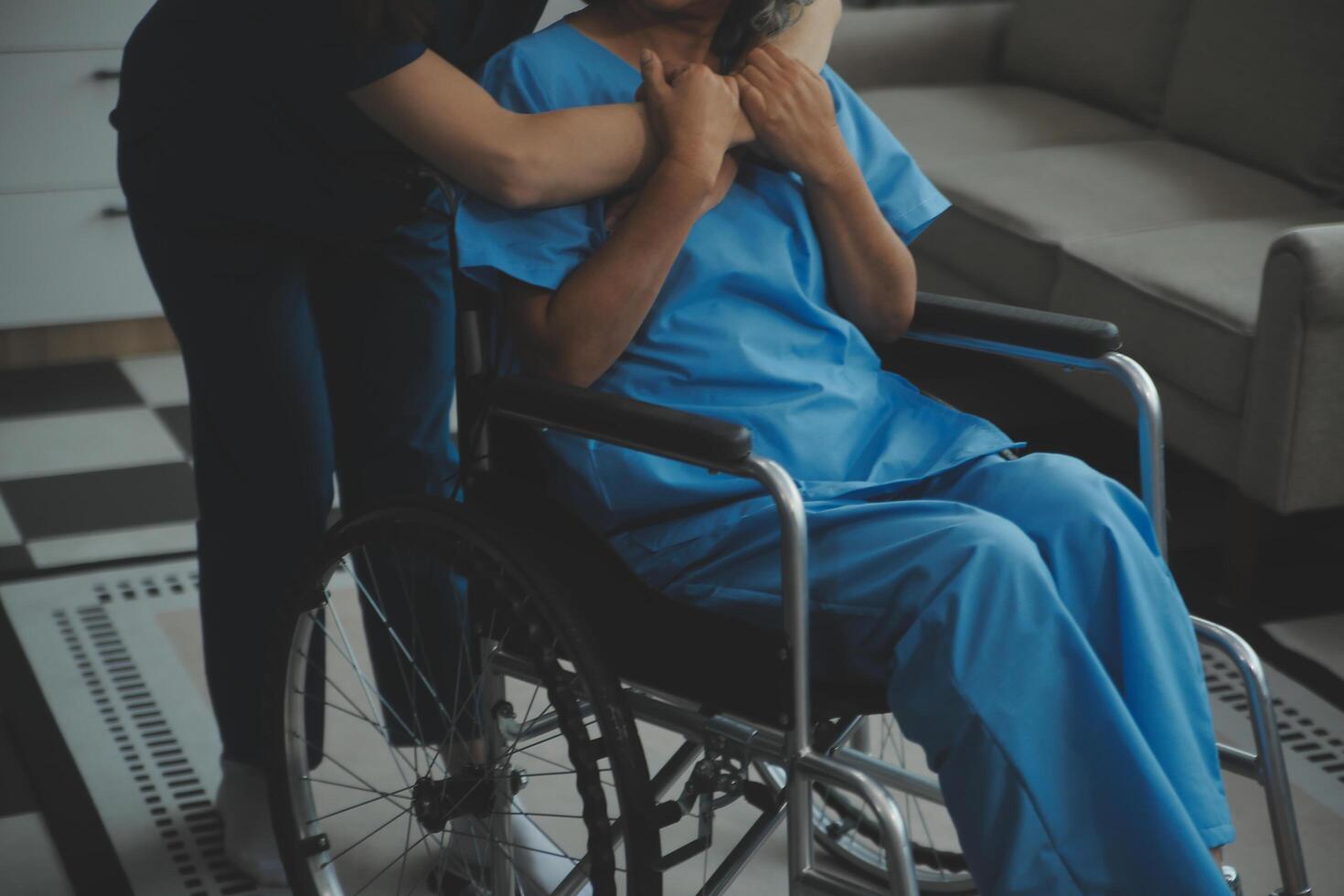 Doctor giving hope. Close up shot of young female physician leaning forward to smiling elderly lady patient holding her hand in palms. Woman caretaker in white coat supporting encouraging old person photo