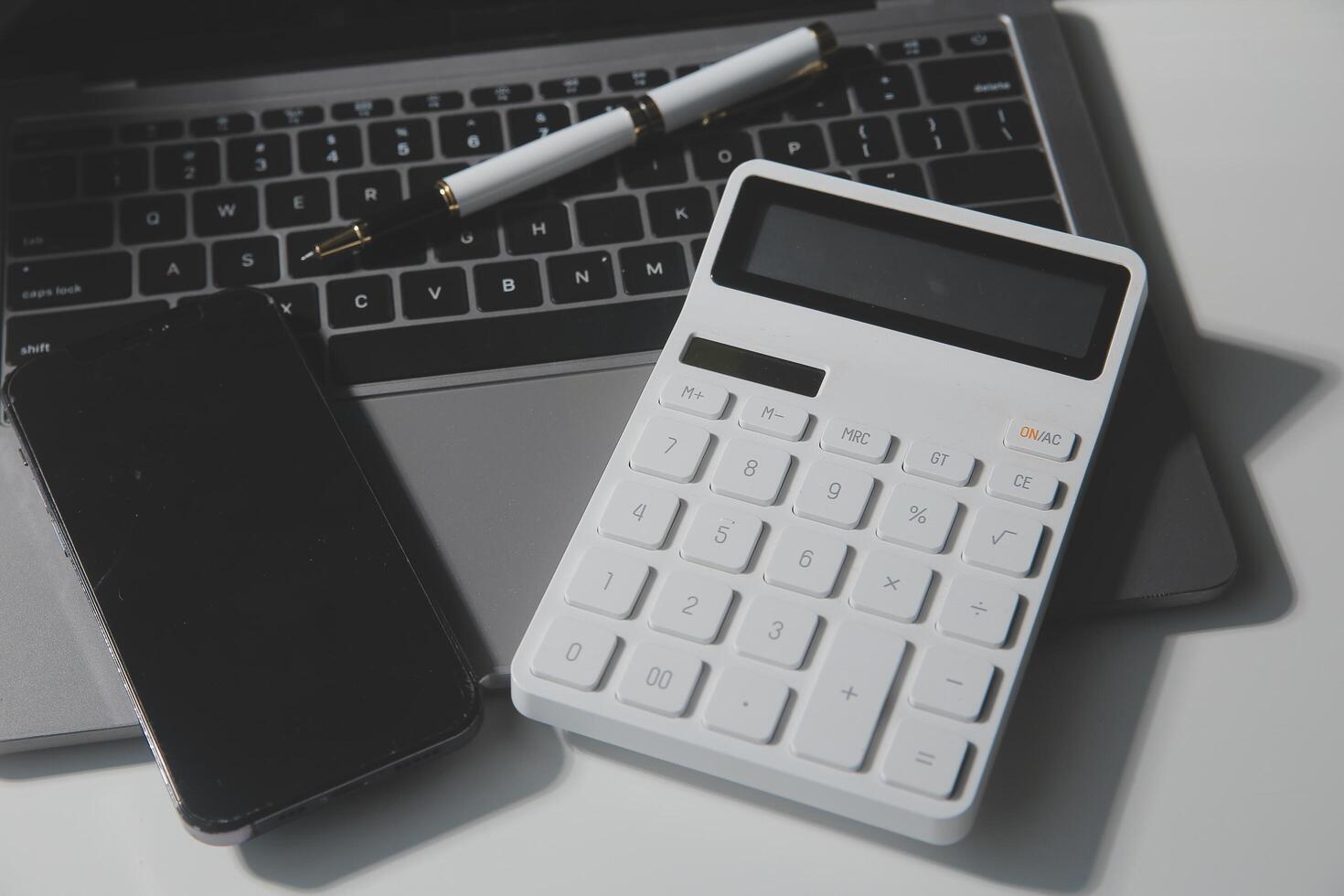 Office leather desk table with calculator and pen. Top view with copy space photo