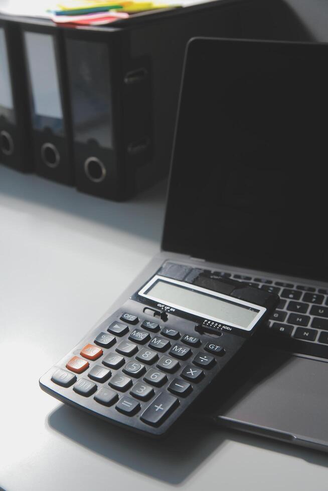 Flat lay, top view office table desk. Workspace with calculator,pen,laptop on white background.Copy Space for text,Empty Blank to word.Business Finance,Education Technology.Work from home. photo