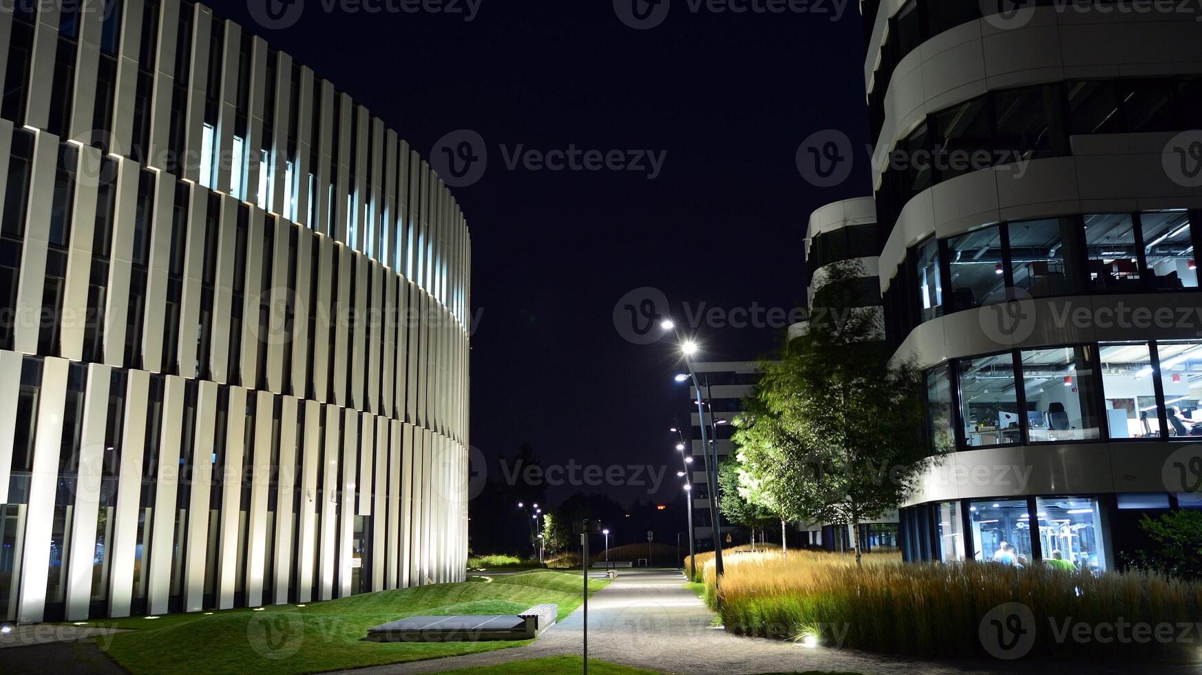 Pattern of office buildings windows illuminated at night. Glass architecture ,corporate building at night - business concept. photo
