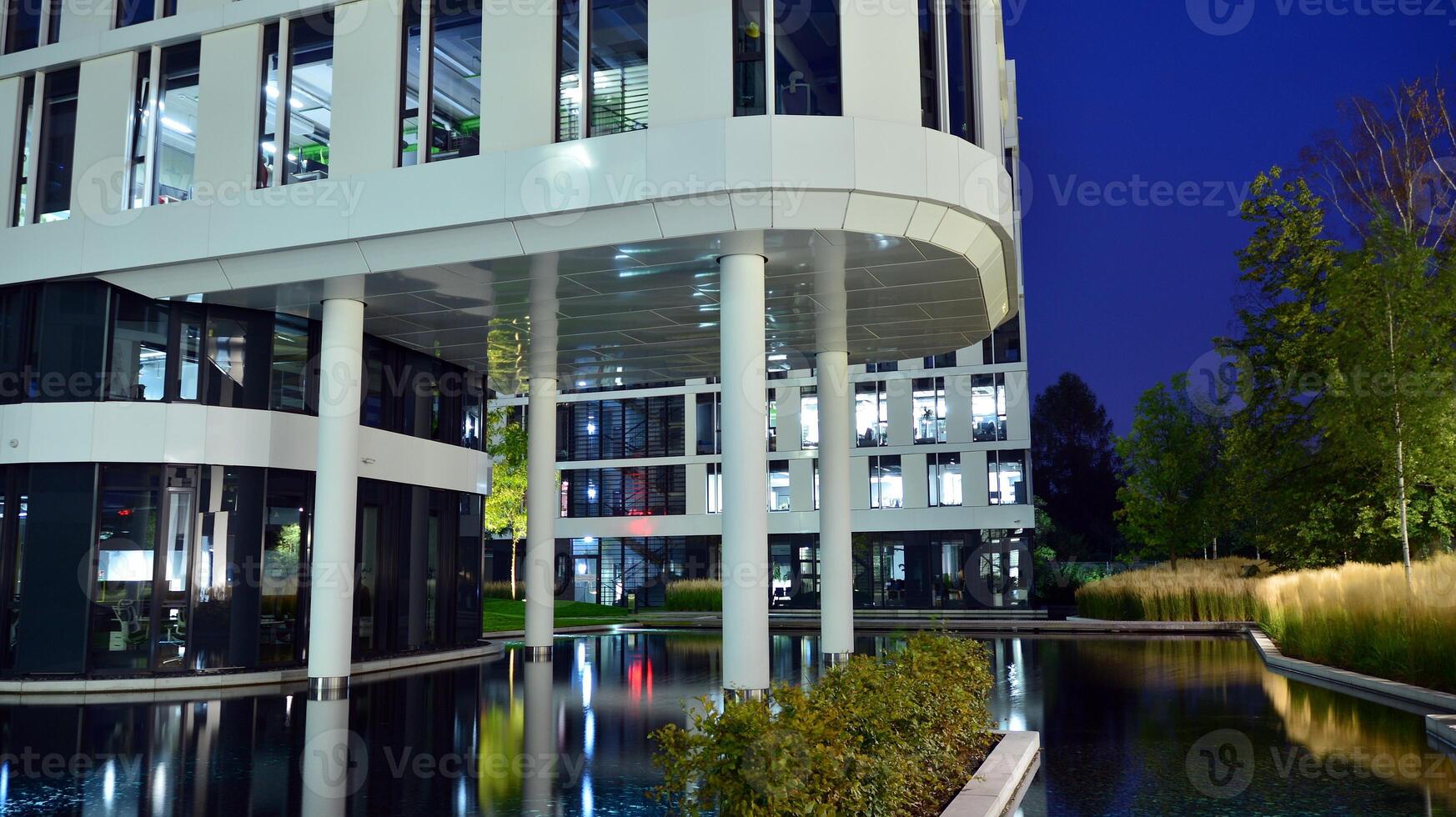 Pattern of office buildings windows illuminated at night. Glass architecture ,corporate building at night - business concept. photo