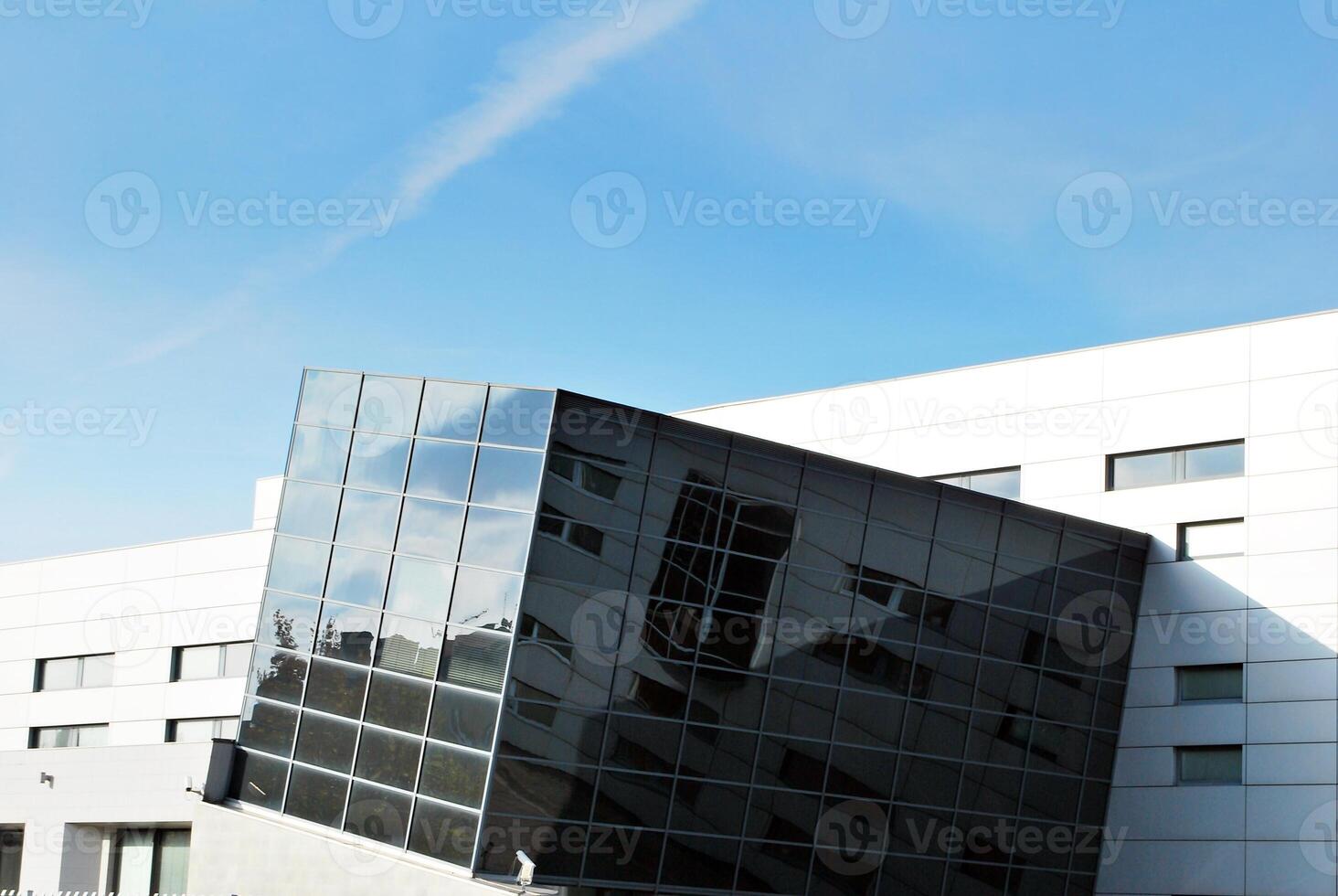 Structural glass wall reflecting blue sky. Abstract modern architecture fragment photo