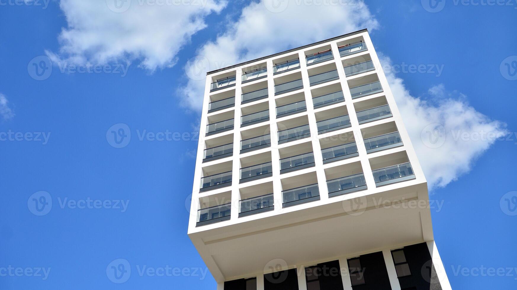 Modern apartment buildings on a sunny day with a blue sky. Facade of a modern apartment building. Glass surface with sunlight. photo