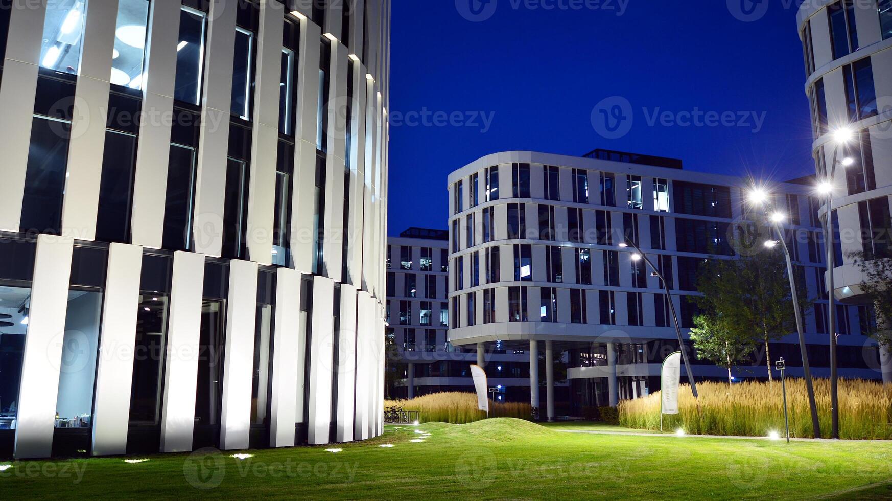 Pattern of office buildings windows illuminated at night. Glass architecture ,corporate building at night - business concept. photo