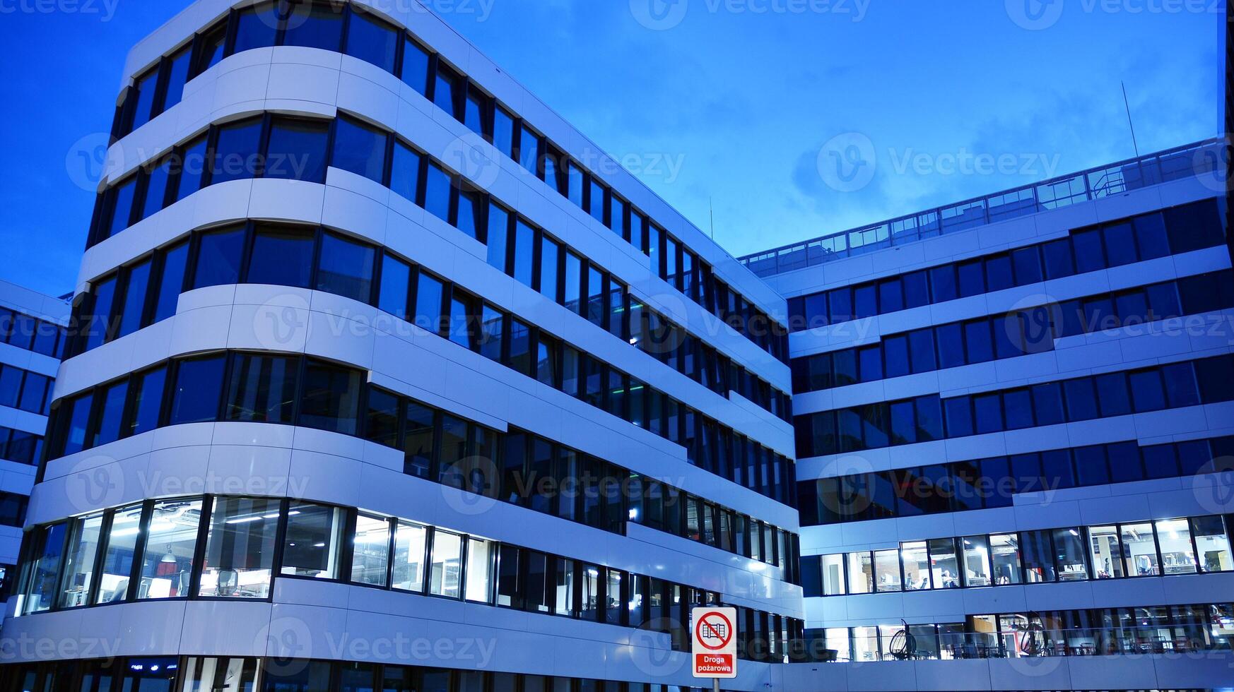 Pattern of office buildings windows illuminated at night. Glass architecture ,corporate building at night - business concept. photo