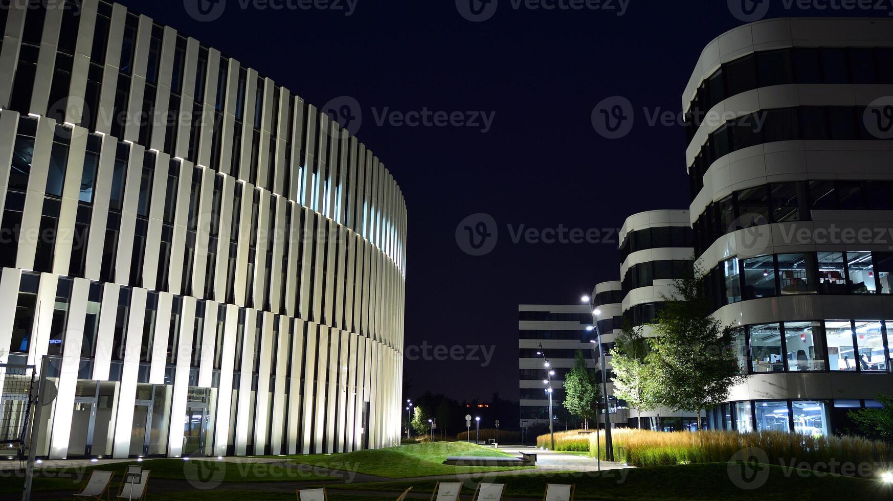 Pattern of office buildings windows illuminated at night. Glass architecture ,corporate building at night - business concept. photo