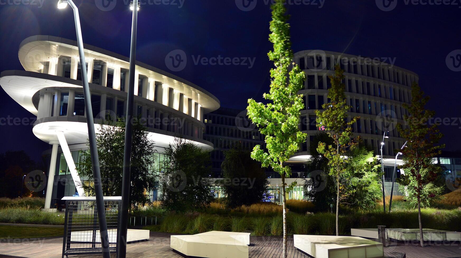 Pattern of office buildings windows illuminated at night. Glass architecture ,corporate building at night - business concept. photo