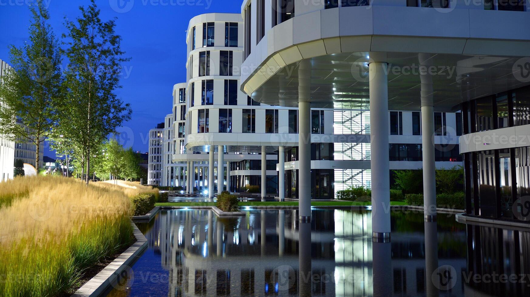 Pattern of office buildings windows illuminated at night. Glass architecture ,corporate building at night - business concept. photo