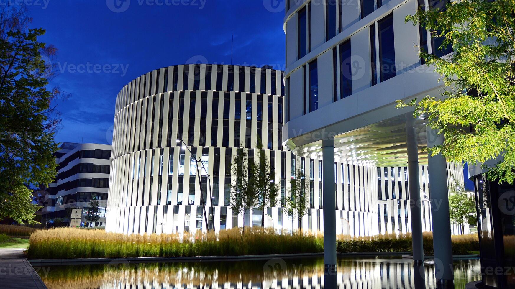 Pattern of office buildings windows illuminated at night. Glass architecture ,corporate building at night - business concept. photo