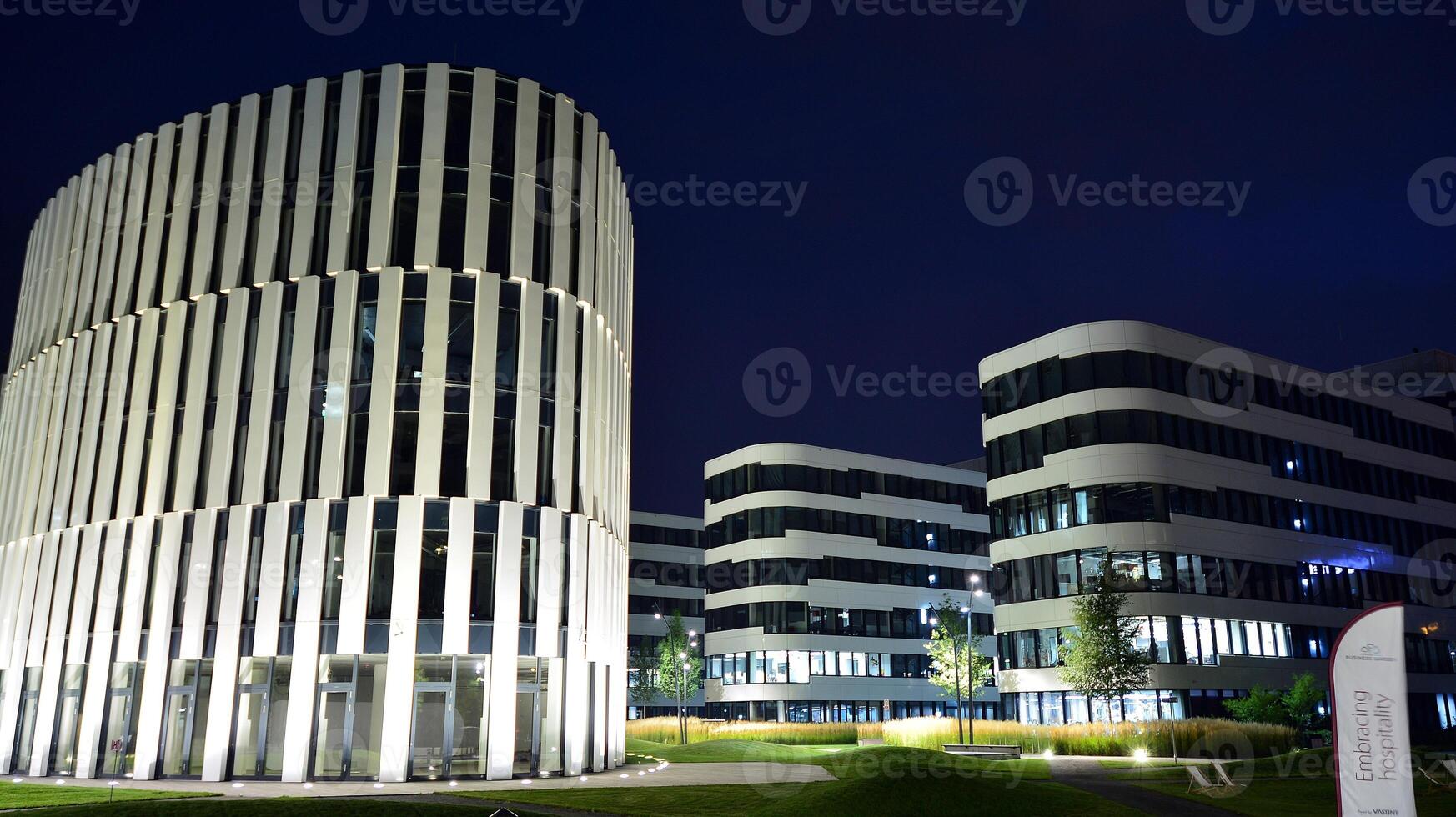 Pattern of office buildings windows illuminated at night. Glass architecture ,corporate building at night - business concept. photo
