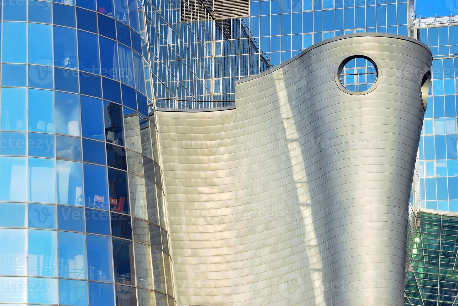 Structural glass wall reflecting blue sky. Abstract modern architecture fragment photo