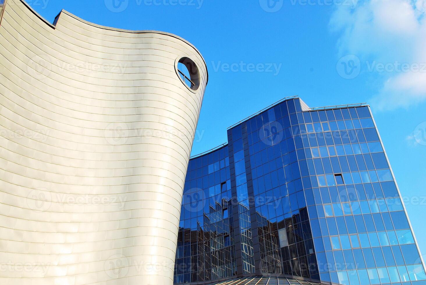 Structural glass wall reflecting blue sky. Abstract modern architecture fragment photo