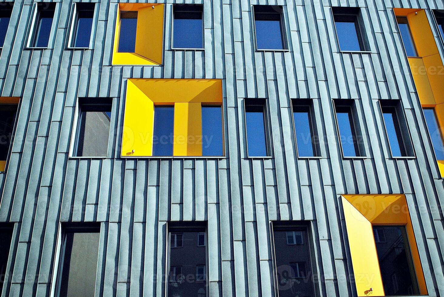Modern office building in the city with windows and steel and aluminum panels wall. photo
