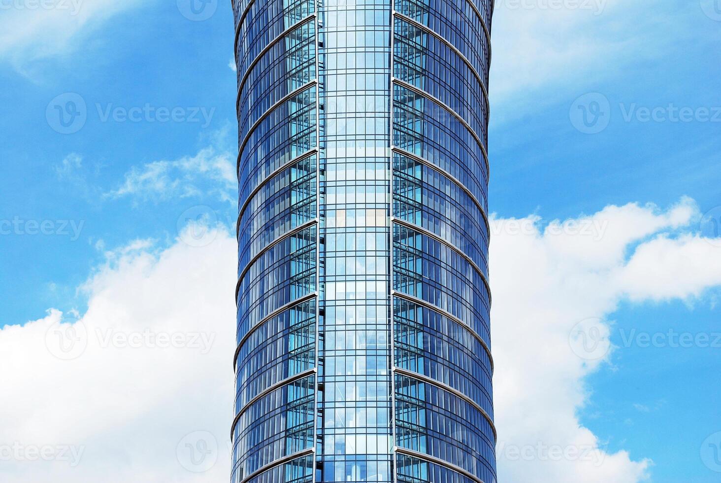 Structural glass wall reflecting blue sky. Abstract modern architecture fragment photo