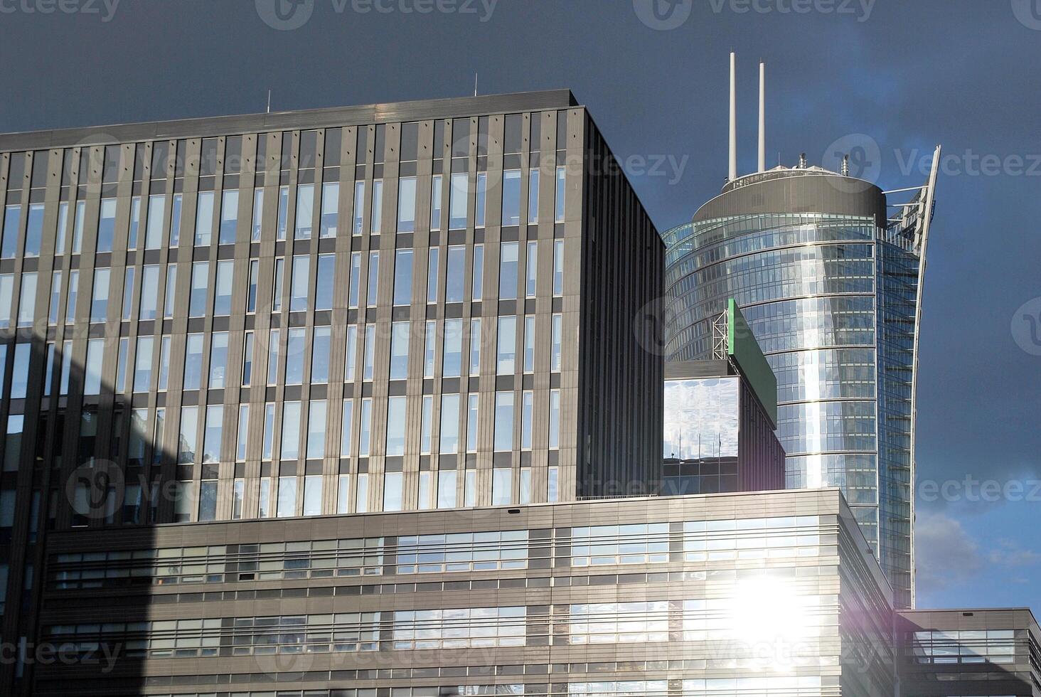 Structural glass wall reflecting blue sky. Abstract modern architecture fragment photo