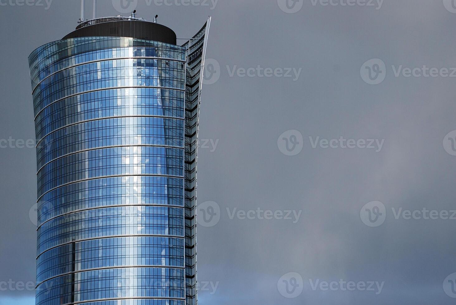 Structural glass wall reflecting blue sky. Abstract modern architecture fragment. photo