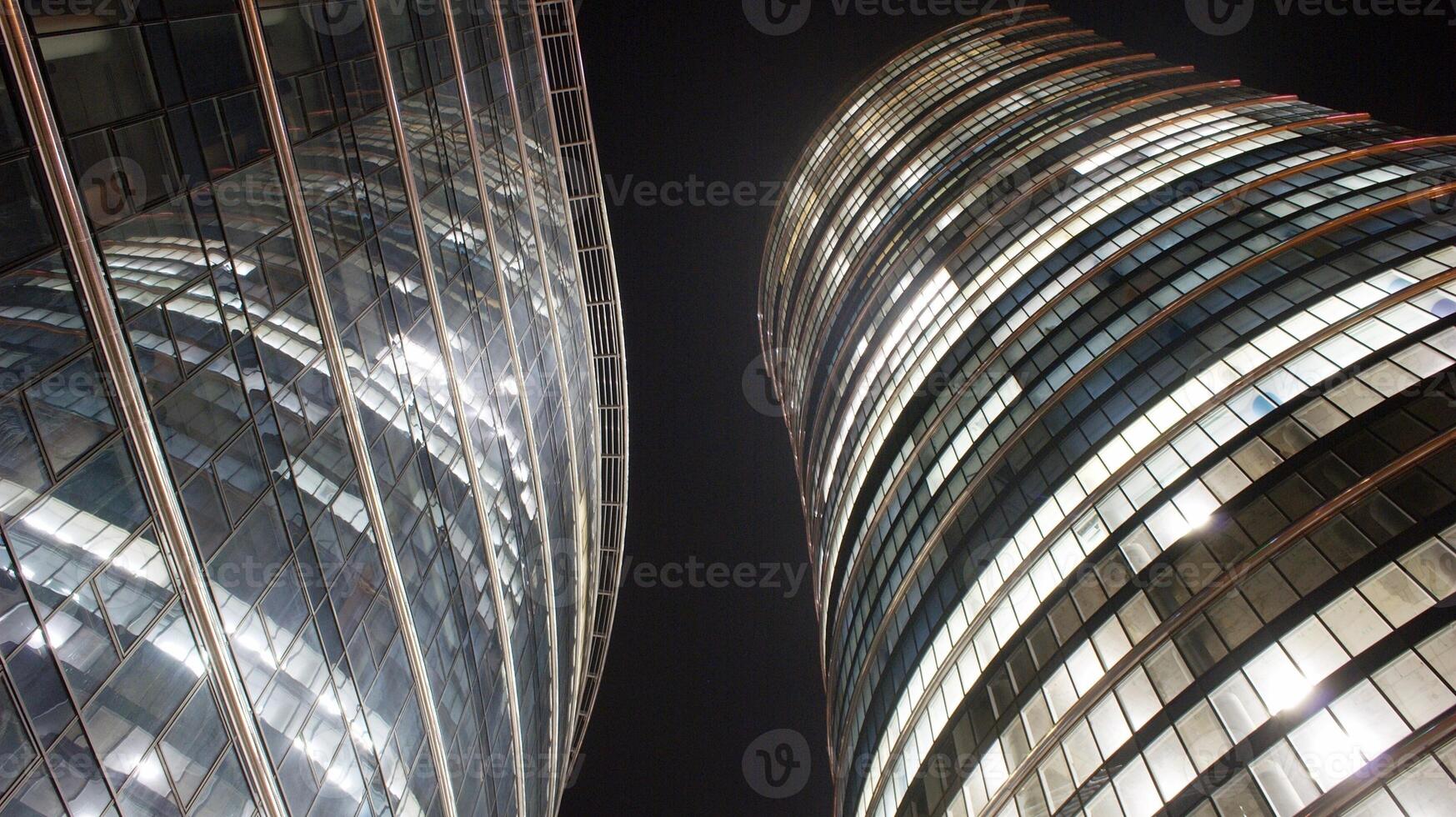 Pattern of office buildings windows illuminated at night. Glass architecture ,corporate building at night - business concept. photo