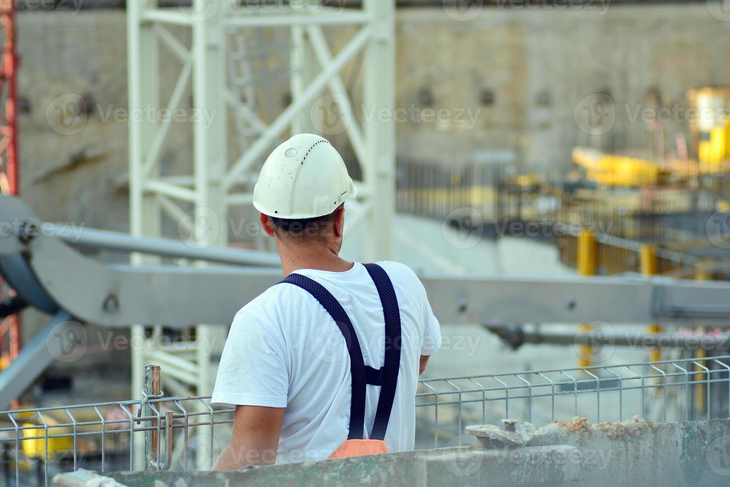 High rise building under construction. Installation of glass facade panels on a reinforced concrete structure. photo