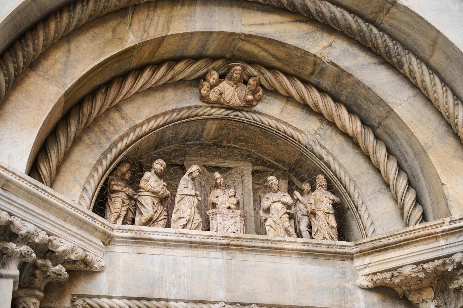 Exterior of the Cathedral in Como city, with Italian architectural details, sculpture, stone carvings. Lombardy. Italy photo