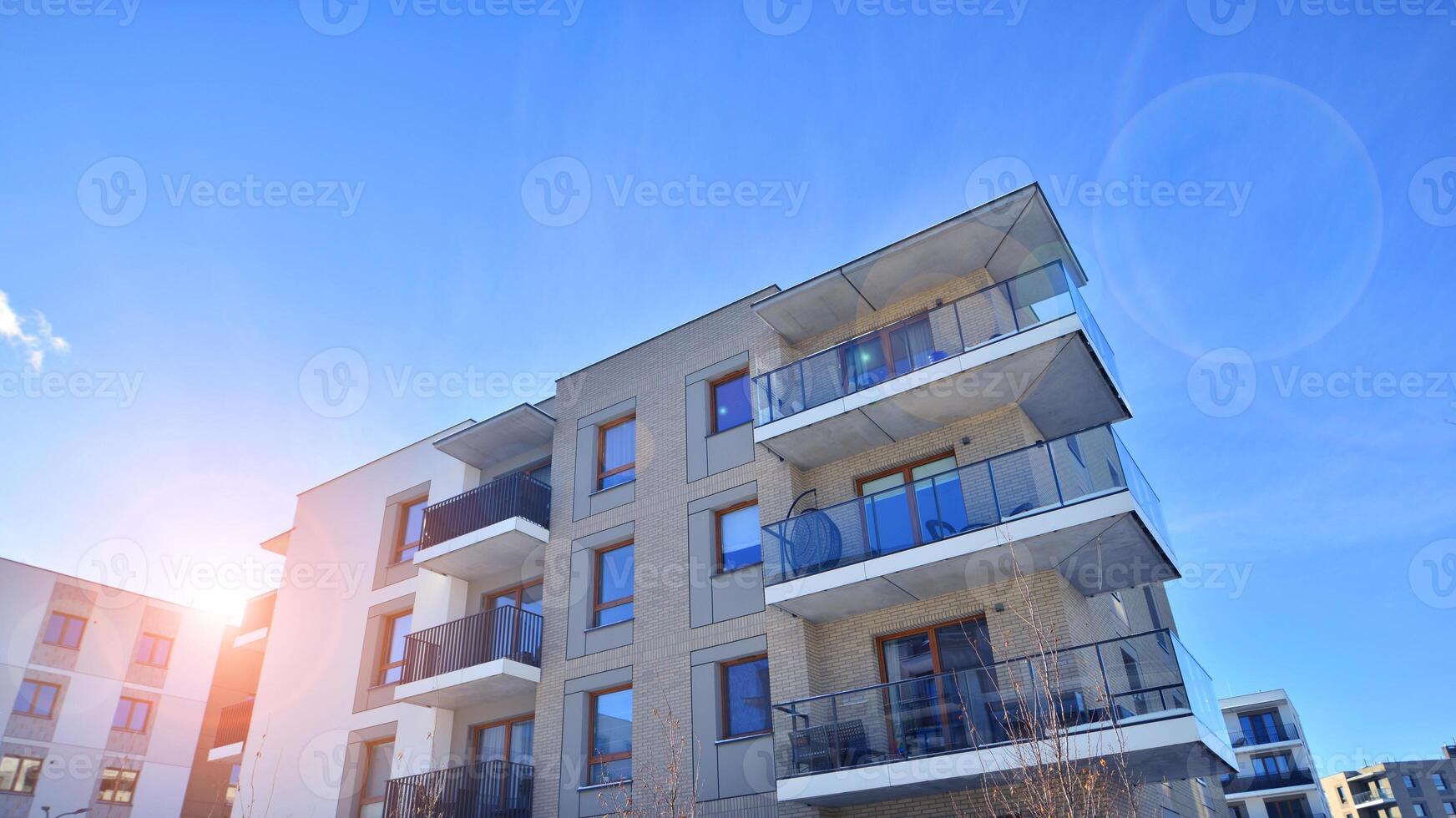 Modern apartment building in sunny day. Exterior, residential house facade. Residential area with modern, new and stylish living block of flats. photo