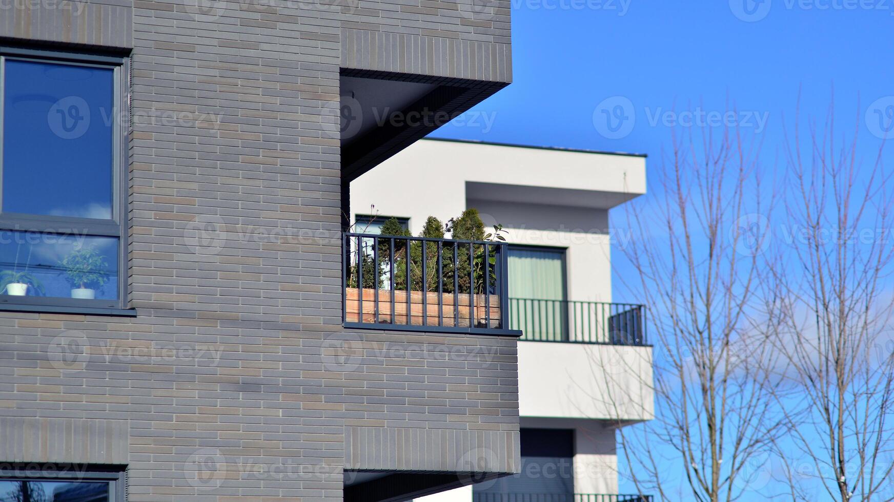Modern apartment building in sunny day. Exterior, residential house facade. Residential area with modern, new and stylish living block of flats. photo