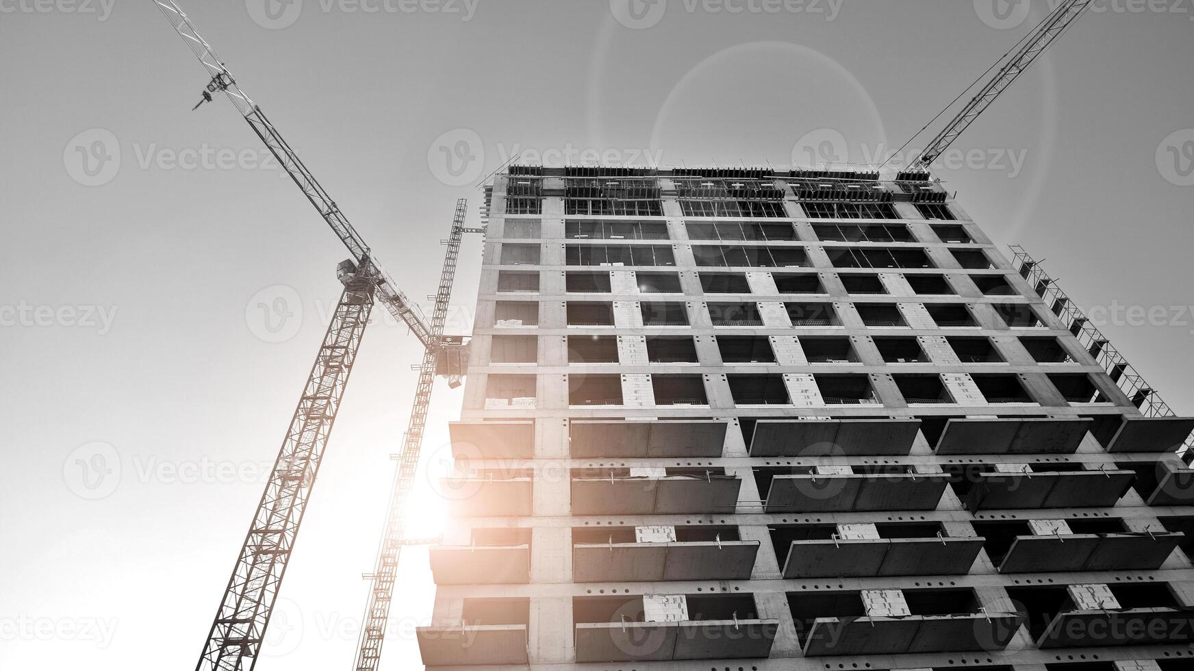Fragment of the building's facade with windows and balconies. Modern apartment buildings on a sunny day. Facade of a modern residential building. Black and white. photo