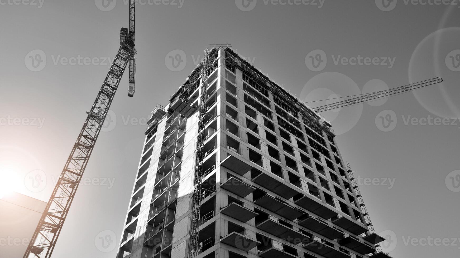 Fragment of the building's facade with windows and balconies. Modern apartment buildings on a sunny day. Facade of a modern residential building. Black and white. photo