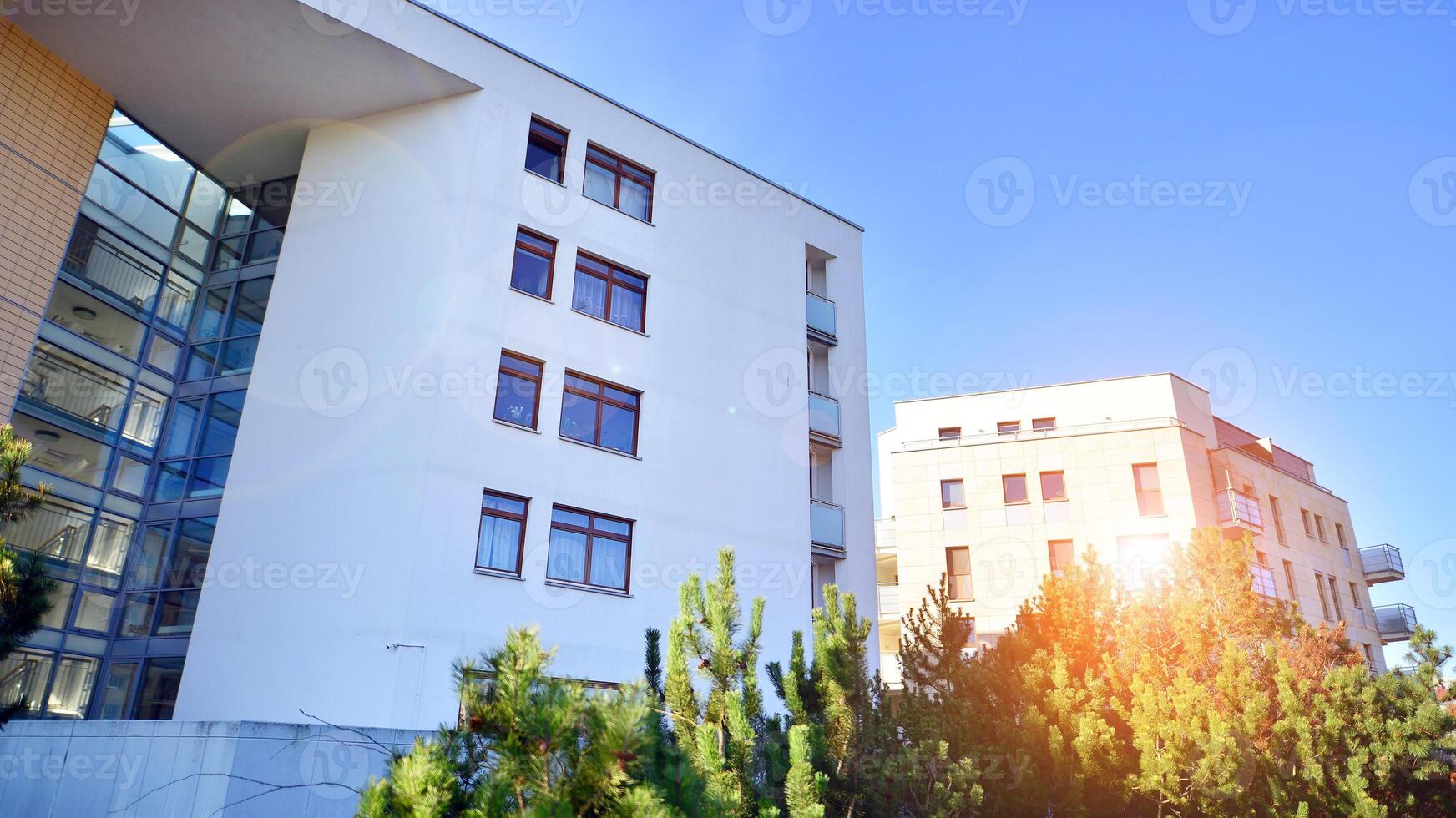 Eco city with modern exterior design of apartment building and landscaping. Garden yard by residential buildings.. Contemporary eco friendly residential architecture. Eco-friendly living in a city. photo