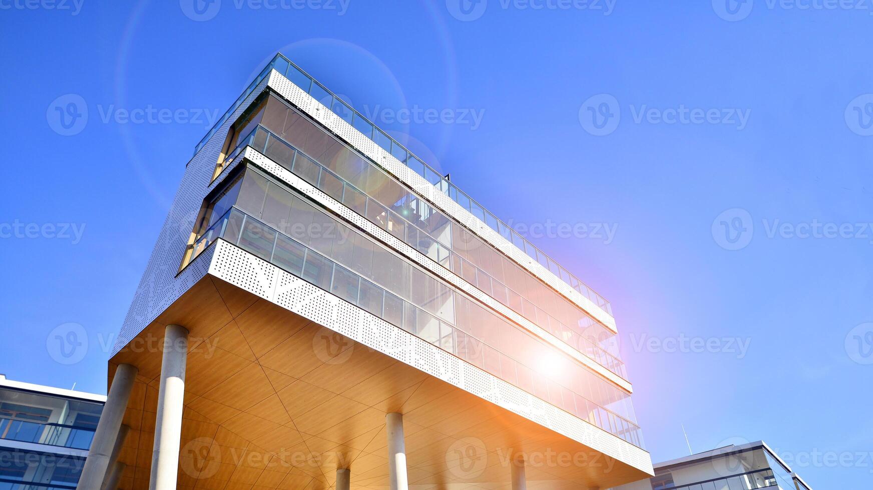 A apartment building with a unique architectural solution. A modern residential building with a white facade and standing on high concrete pillars. photo