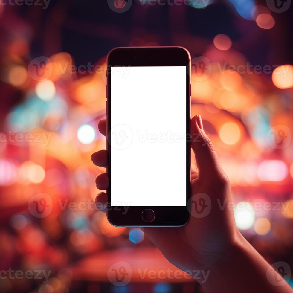 Woman hand holding black smartphone at concert photo