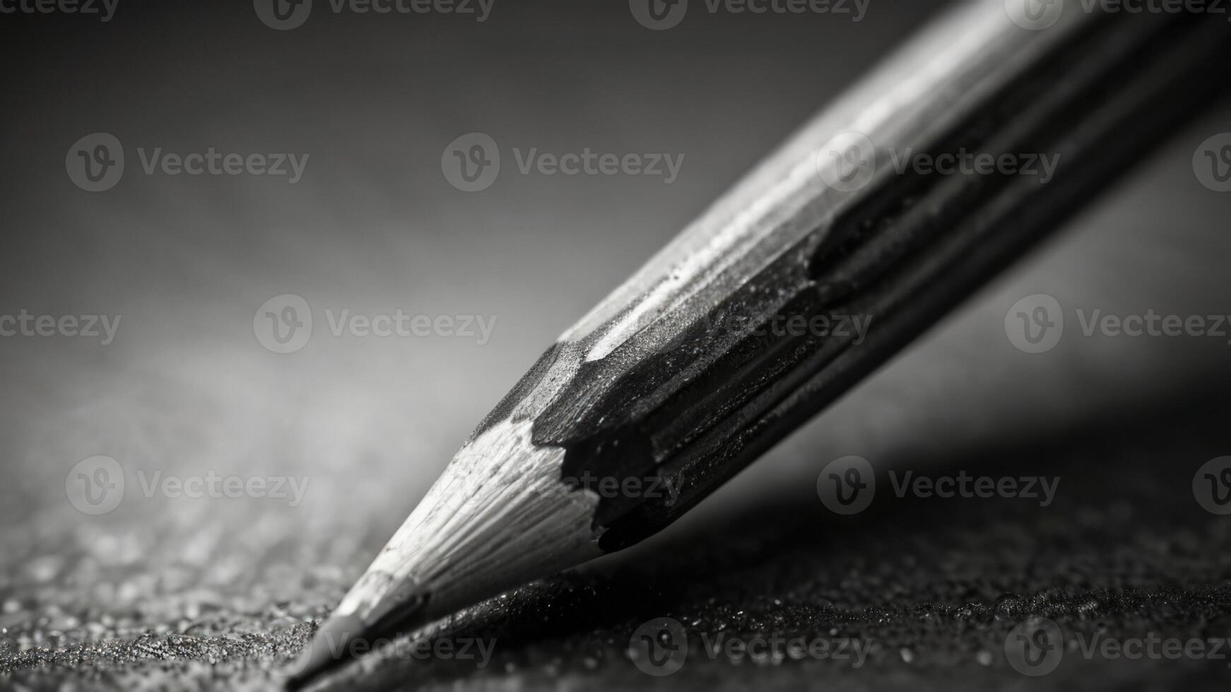 a close up of a pencil on a table black and white photo