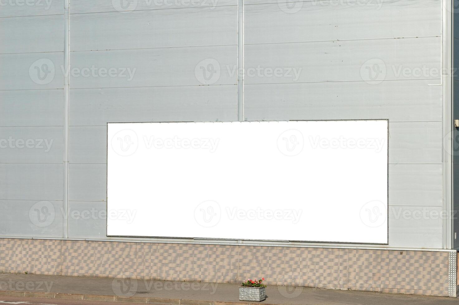 Billboard layout on the wall of the building. Gray city building with a billboard. photo