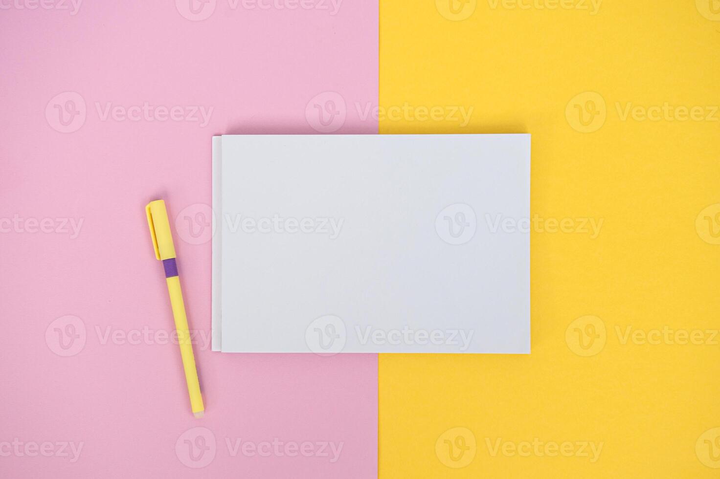 Clipboard with a white sheet and a pen on a colored background. View from above. place for text photo