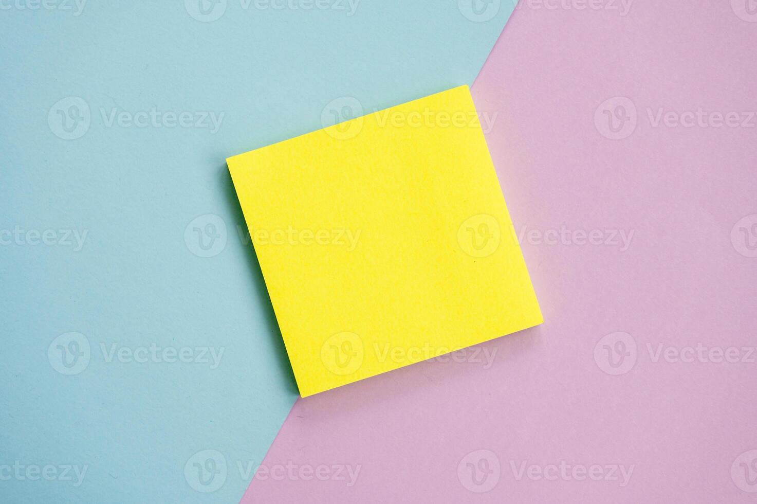 Top view of yellow sheets stickers on a blue and purple background Mockup with a notebook , sheets for notes photo