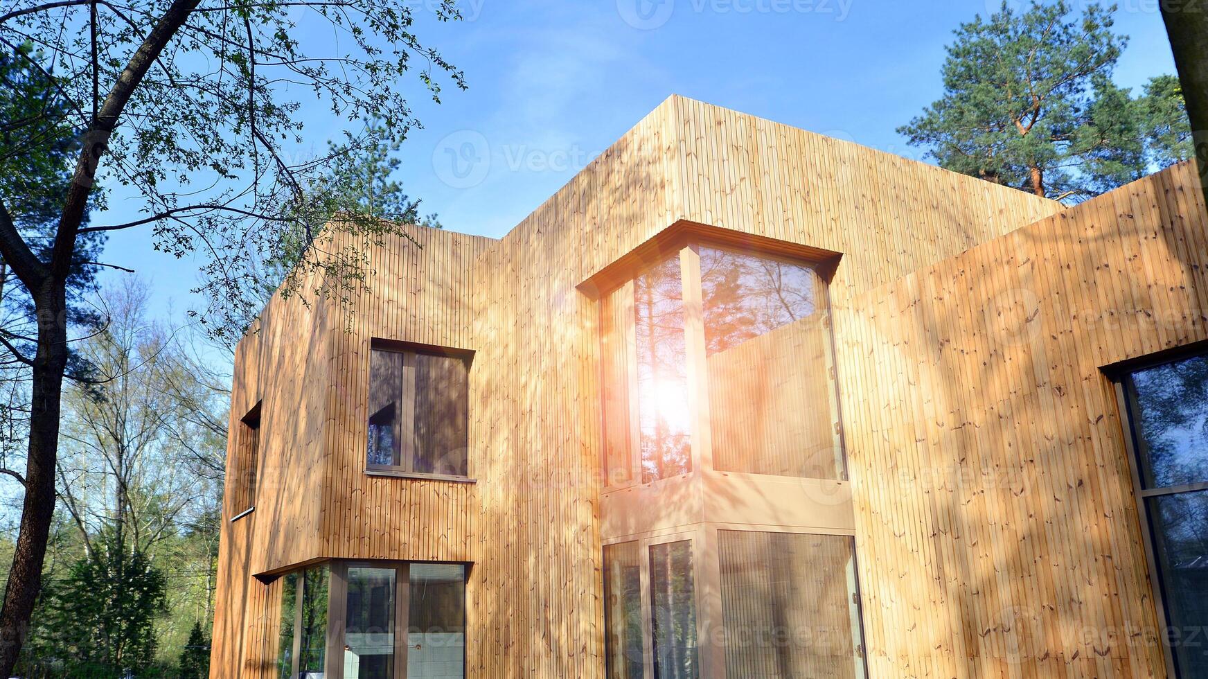 New single family house. Residential home with modern wooden facade. photo