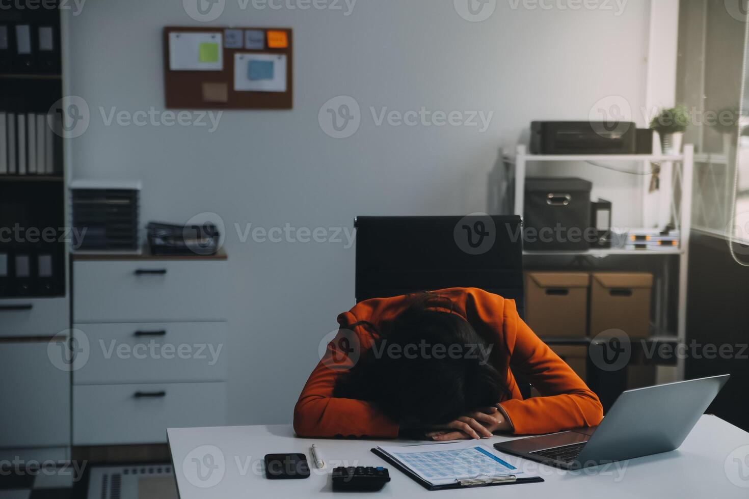 Portrait of tired young business Asian woman work with documents tax laptop computer in office. Sad, unhappy, Worried, Depression, or employee life stress concept photo