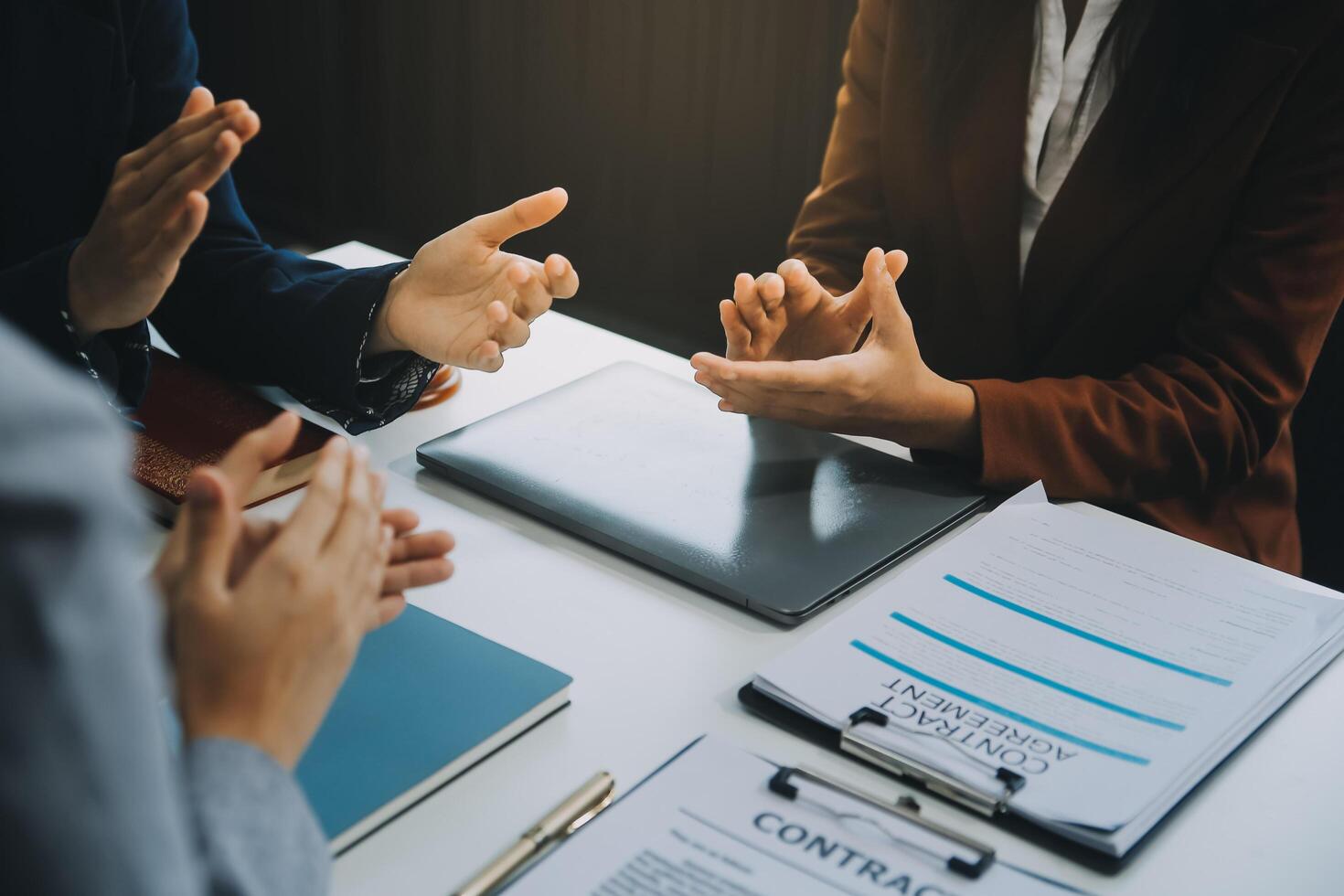 Business people clapping and applause at meeting or conference, close-up of hands. Group of unknown businessmen and women in modern white office. Success teamwork or corporate coaching concept photo