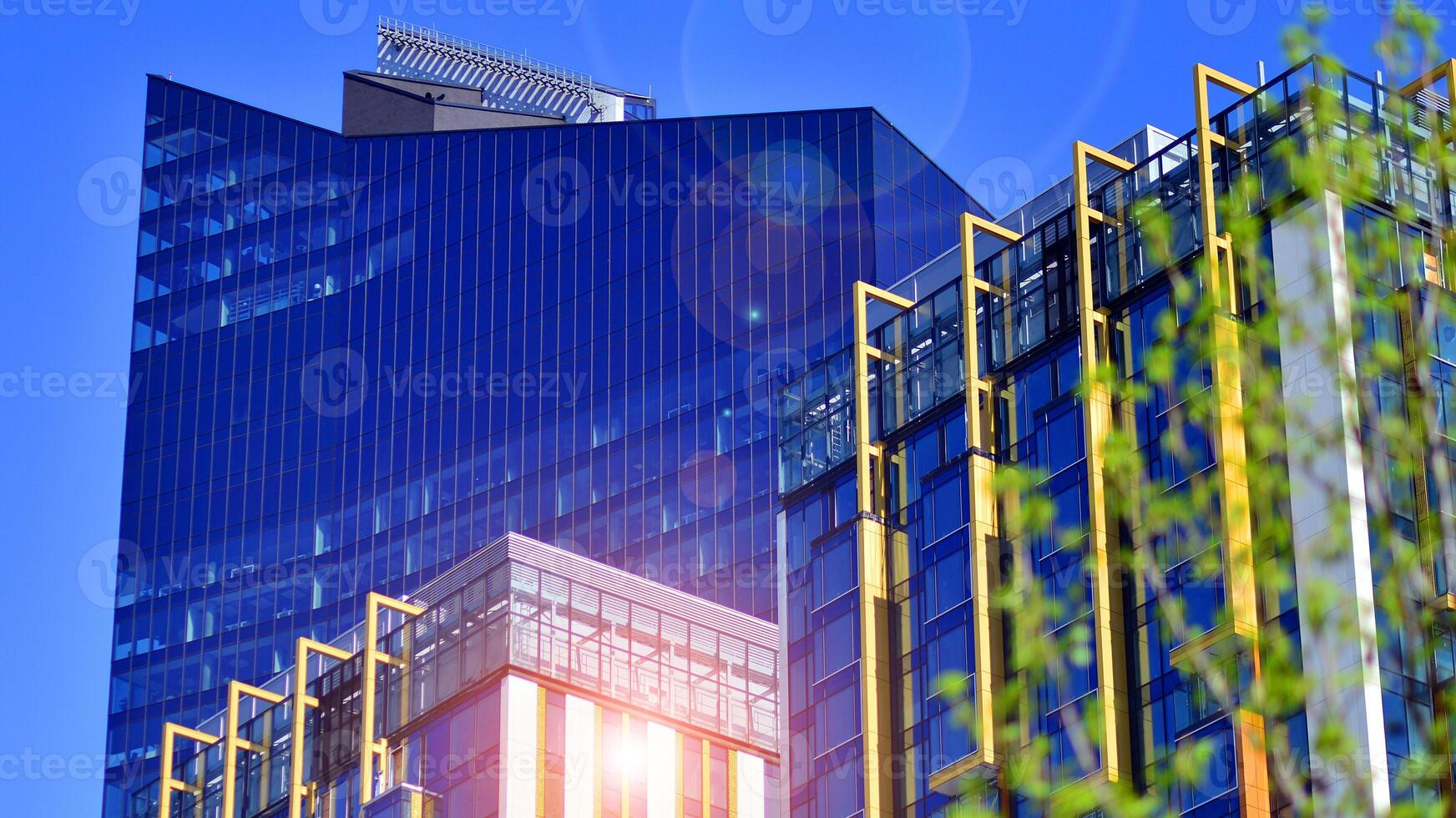 Eco architecture. Green tree and new residential building. Harmony of nature and modernity. Modern apartment building with new apartments in a green residential area. photo