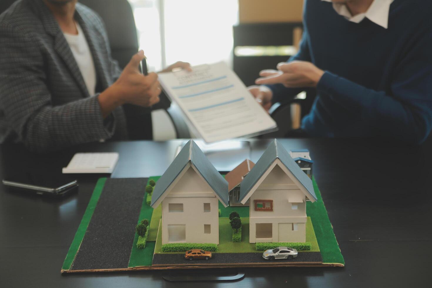 Team of architectures and businessmen discussing and brainstorming on floor plan modification for real estate investment and housing development project photo
