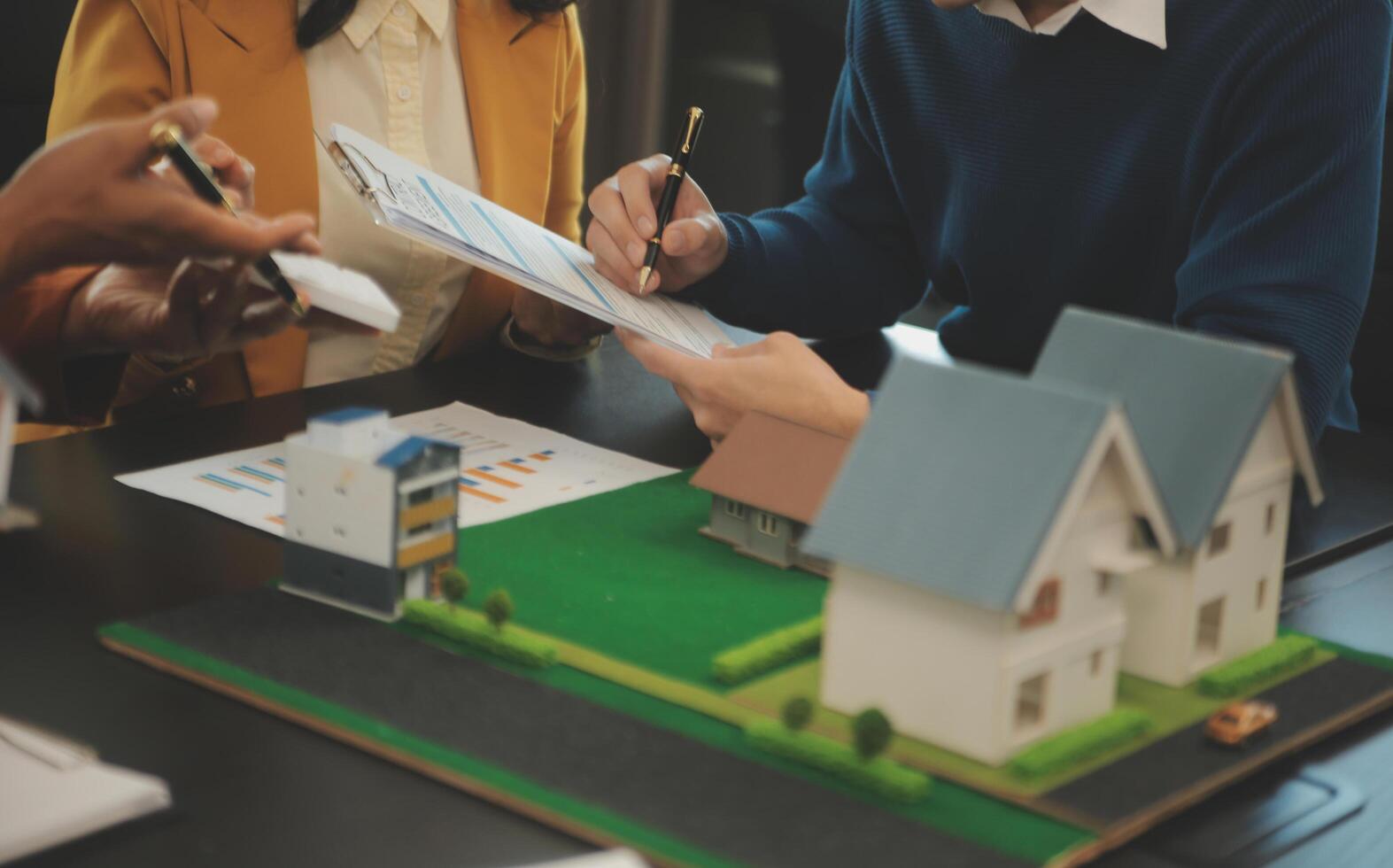 Team of architectures and businessmen discussing and brainstorming on floor plan modification for real estate investment and housing development project photo